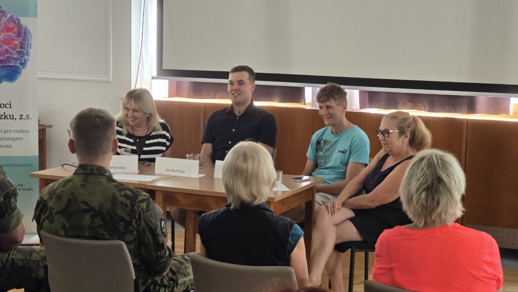 Intelektuální diskuse o duševním zdraví a neurovědách s panelisty v konferenčním sále.